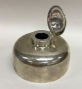 An unusual large silver circular inkwell with hing