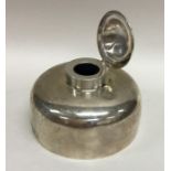 An unusual large silver circular inkwell with hing