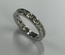 A diamond full eternity ring set in platinum. Fing