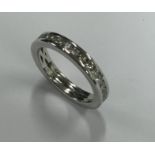 A diamond full eternity ring set in platinum. Fing