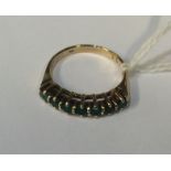 An emerald and diamond half hoop ring in gold. Est