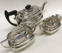 A silver three piece tea service with ebony handle