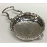 A Georgian silver lemon strainer with pierced bowl