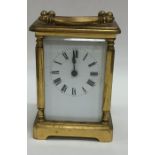 A small brass carriage clock on bracket feet. Est.