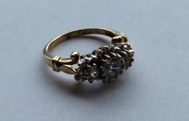 A 10 carat gold triple cluster ring in claw mount.