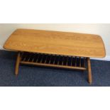 An Ercol occasional table on tapering supports. Es