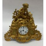 A good French gilt mantle clock with finial top. E