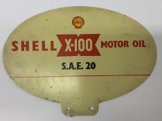 A small oval "Shell X-100 Motor Oil S.A.E 20" doub