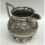 A heavy silver Indian cream jug decorated with fig