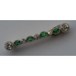 An attractive emerald and diamond nine stone brooc