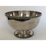 A large silver plated punch bowl with gadroon rim.