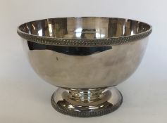 A large silver plated punch bowl with gadroon rim.