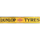 A large rectangular "Dunlop Tyres" metal sign mou