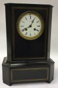 A French ebony mantle clock with white enamelled d