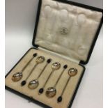 A boxed set of six silver bean top coffee spoons.