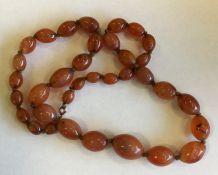 A graduated string of agate beads with ring clasp.