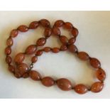 A graduated string of agate beads with ring clasp.