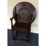 An oak carved hall chair with circular back. Est.