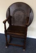 An oak carved hall chair with circular back. Est.