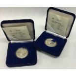 Two Singapore proof silver coins in fitted boxes.