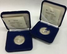 Two Singapore proof silver coins in fitted boxes.
