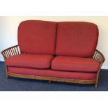 A massive Ercol three piece settee suite with red