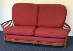 A massive Ercol three piece settee suite with red