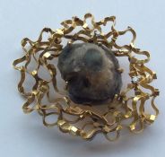 An 18 carat gold modernistic brooch inset with dia