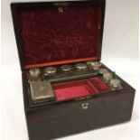 A rosewood travelling vanity case with fitted inte