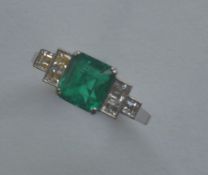 A good rare Art Deco emerald and diamond seven sto