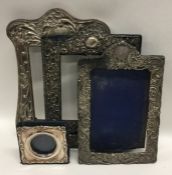 A group of three embossed silver picture frames de