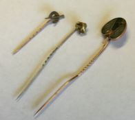 A high carat gold mounted stick pin in the form of