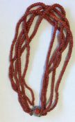 A graduated string of coral beads with silver clas