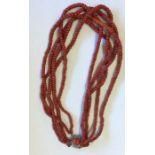 A graduated string of coral beads with silver clas