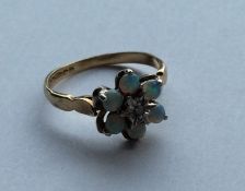 An opal and diamond daisy head cluster ring in 9 c