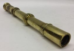 An unusual brass telescope with engine turned hand