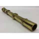 An unusual brass telescope with engine turned hand