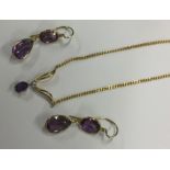 An amethyst and diamond drop pendant together with