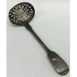 A fiddle pattern silver sifter spoon. London. By R