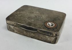 A silver hinged top cigarette box with enamelled m
