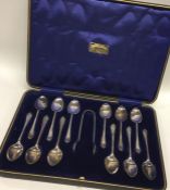 A boxed set of twelve silver coffee spoons with ma