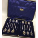 A boxed set of twelve silver coffee spoons with ma