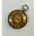 A 9 carat lady's fob watch with gilt dial. Approx.