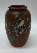 A Japanese pottery vase decorated with frogs. Sign