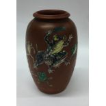 A Japanese pottery vase decorated with frogs. Sign