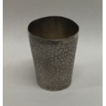 A tapered silver Indian beaker with floral decorat