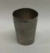 A tapered silver Indian beaker with floral decorat