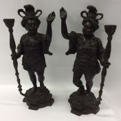 A pair of large heavy bronze Blackamoor figures wi