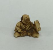 A small modern netsuke in the form of a Buddha in