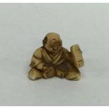 A small modern netsuke in the form of a Buddha in